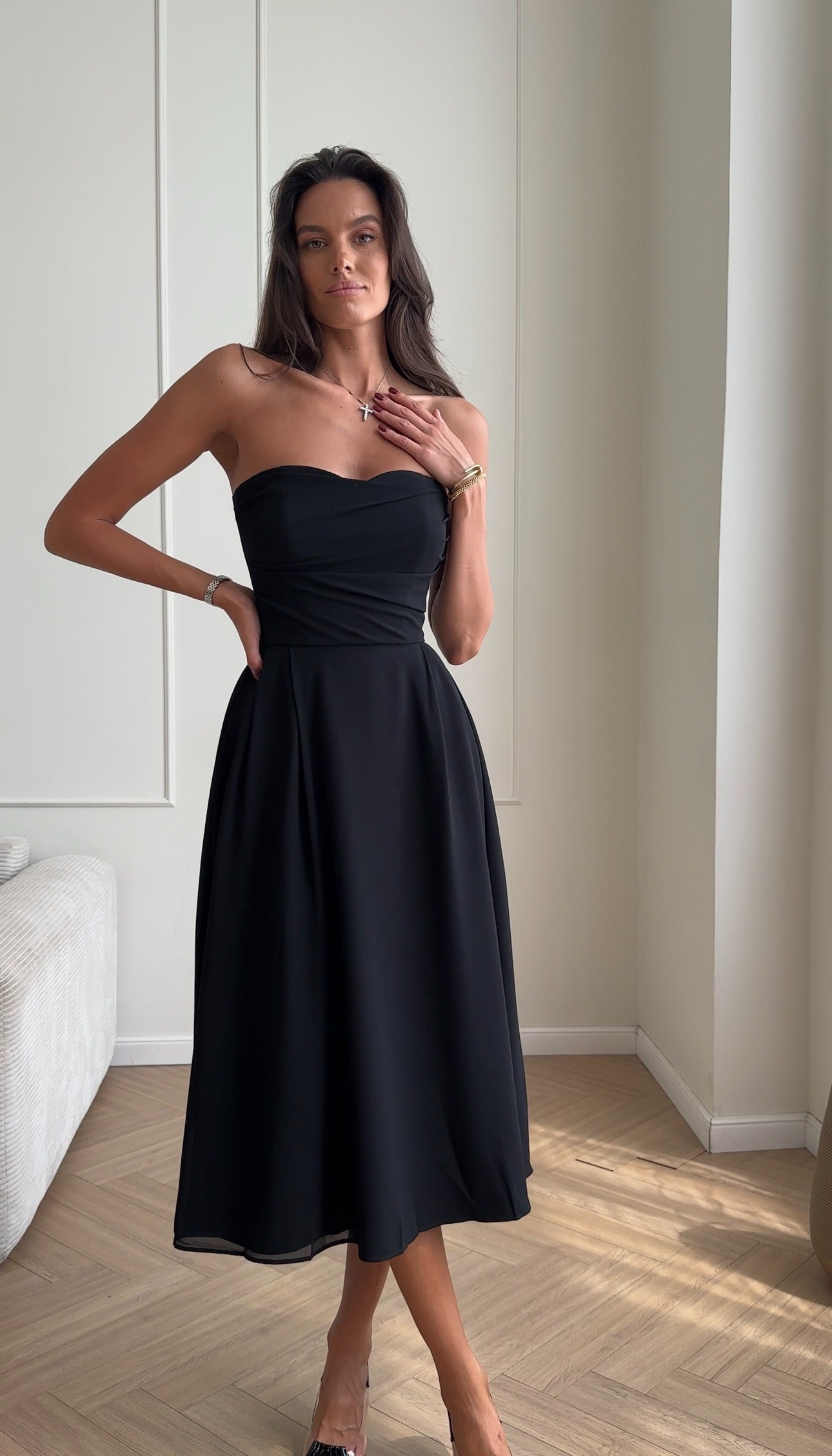Bustier dress with a draped bodice and a pleated skirt