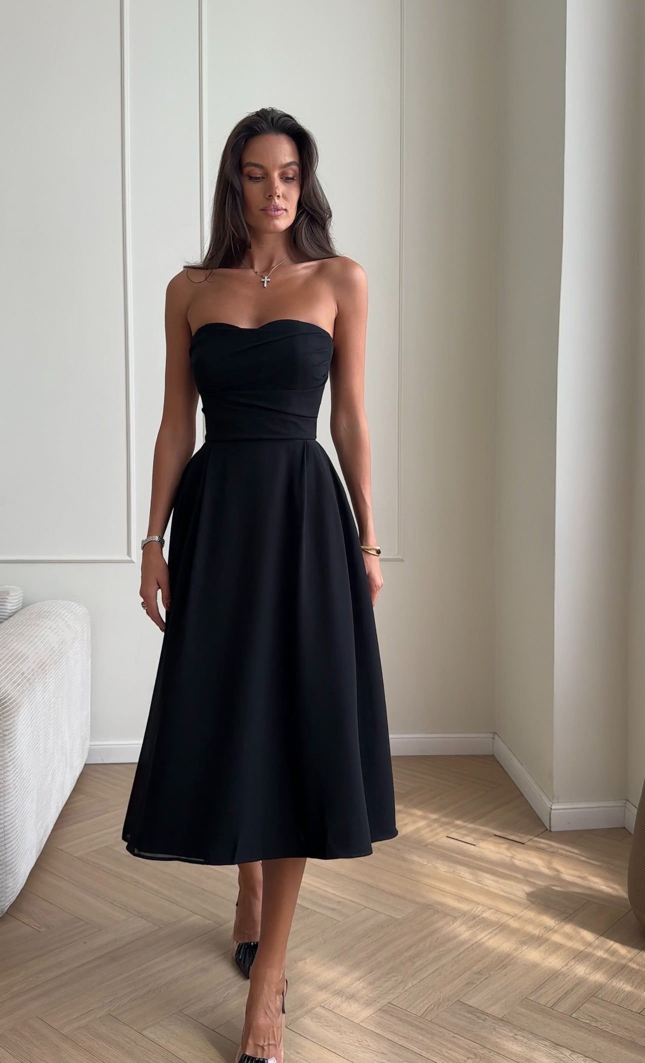 Bustier dress with a draped bodice and a pleated skirt