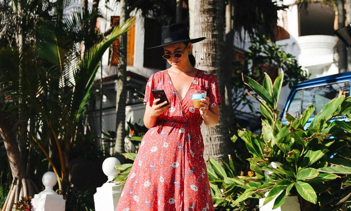 Red floral midi dress among tropical plants