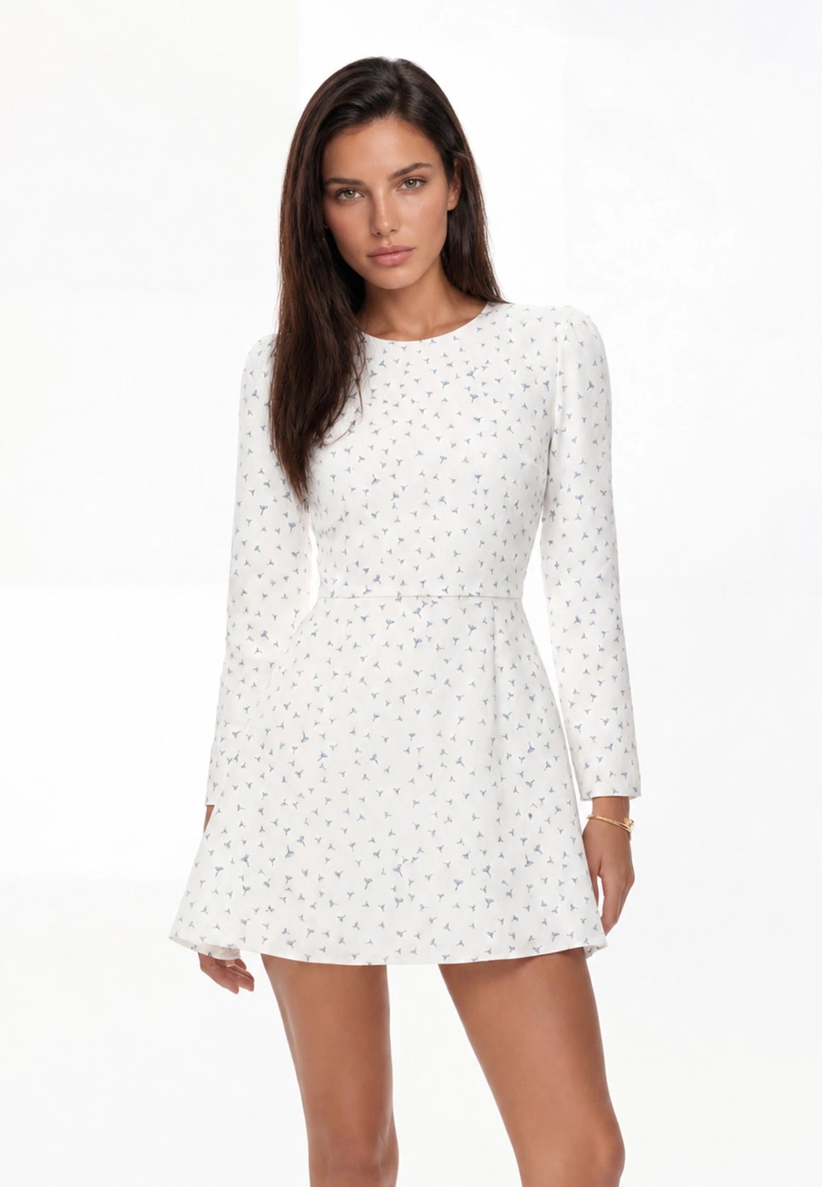 White floral mini dress with long sleeves, on model — front
