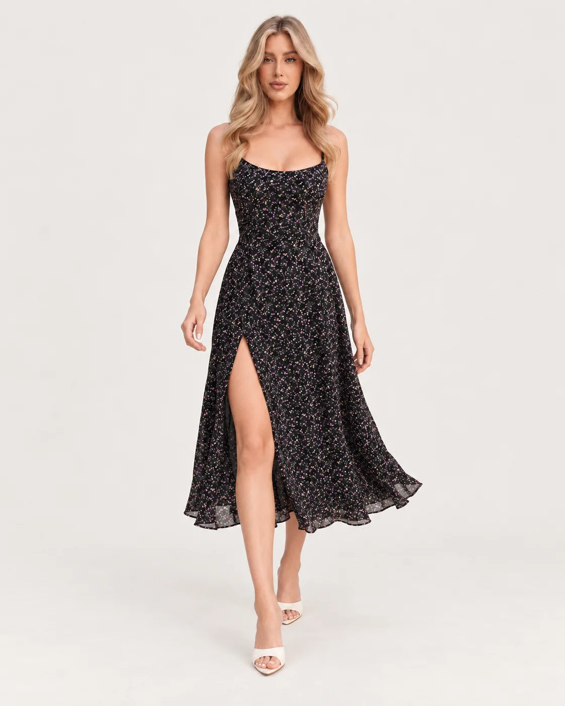 Black printed midi dress with straps and a slit skirt — walking